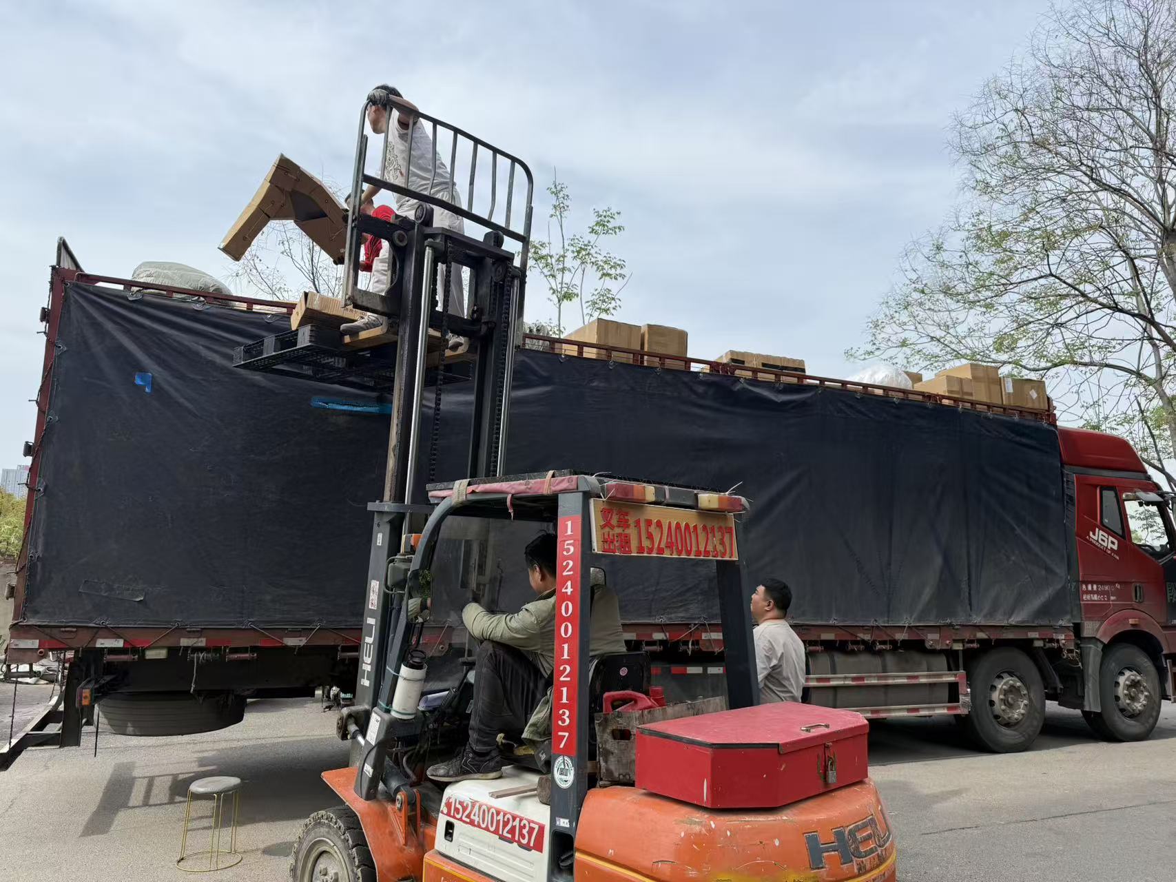 Forklift loading packed auto parts for transport